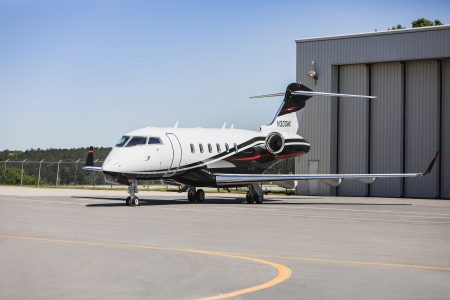 A detailed cabin perspective highlighting one of the executive passenger seats aboard N300WK. The seating arrangement supports both relaxation and productivity while showcasing the refined interior finishes found throughout the aircraft.