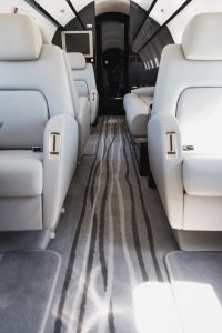 Bombardier Challenger 300 N300WK cabin aisle showcasing executive seating, premium flooring, and spacious passenger accommodations.