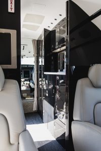 Bombardier Challenger 300 N300WK galley entry area featuring premium cabinetry, storage compartments, and executive travel amenities.