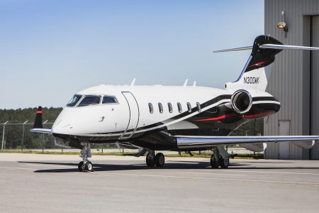 Bombardier Challenger 300 N300WK positioned on the airport apron highlighting its forward fuselage, cockpit windows, and executive aviation profile.