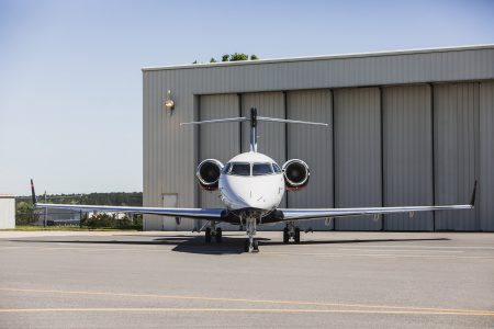 Bombardier Challenger 300 N300WK viewed directly from the front showcasing cockpit windows, engines, landing gear, and aircraft symmetry.